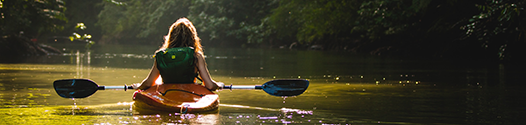 Girl kayaking on river